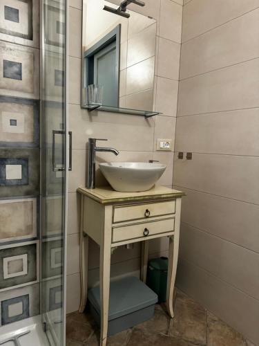 a bathroom with a sink and a shower at Il Racconto Acqua in Nocera Umbra