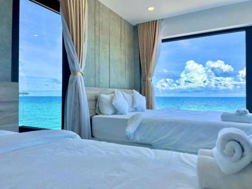 a bedroom with a bed with a view of the ocean at New Moon Hotel Phu Quy in Cu Lao Thu