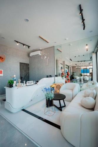a living room with a white couch and a table at New Moon Hotel Phu Quy in Cu Lao Thu
