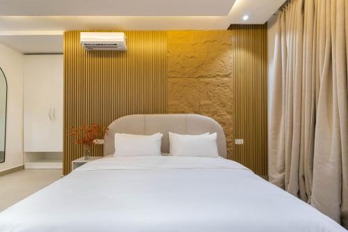 a bedroom with a large white bed with white pillows at Luxury 2 bedroom with water view phase 1 in Lekki