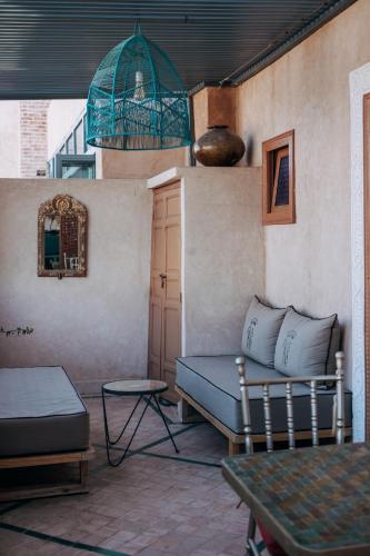 a living room with a couch and a bird cage at Riad Ksar Al Amal & Spa in Marrakech