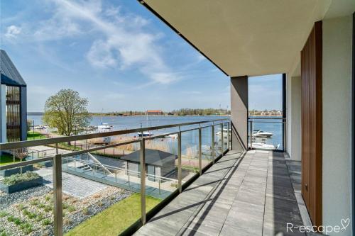 a balcony with a view of the water at R-escape Apartamenty Ostróda in Ostróda