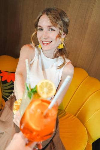 a woman sitting in a chair holding a drink at Boutique House happYellow Saalbach, inkl JokerCard in Saalbach Hinterglemm