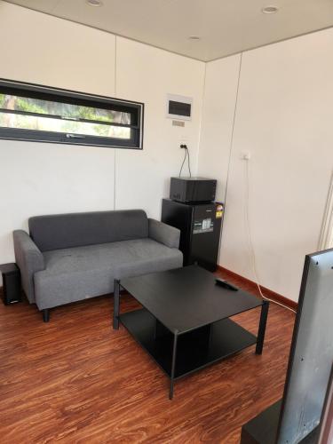 a living room with a couch and a coffee table at Woodland Edge in Greenvale