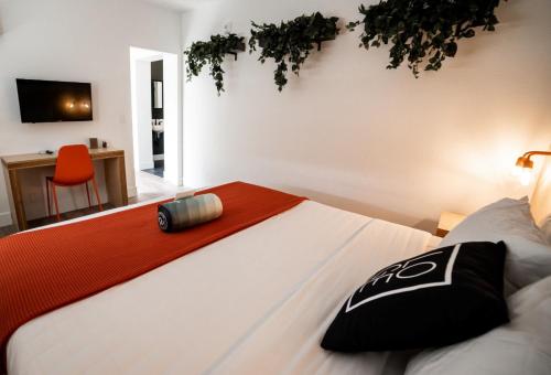 a bedroom with a bed with a red towel on it at LOGE Leavenworth - Downtown in Leavenworth