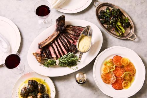 a table with plates of food and glasses of wine at Francis Hotel Bath in Bath