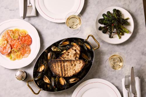 a table with a plate of mussels and a plate of food at Francis Hotel Bath in Bath