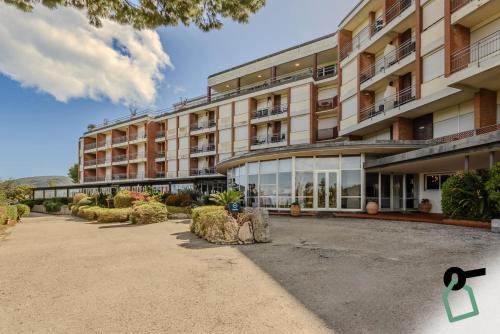 a large apartment building with a lot of windows at HOTIDAY Room Collection - Porto Azzurro in Capoliveri