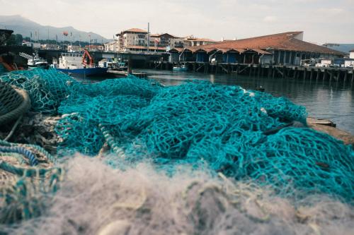 a pile of blue nets sitting in the water at Boutique Hôtel Txoko in Saint-Jean-de-Luz