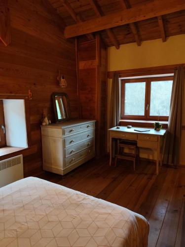 a bedroom with a bed and a desk and a window at Gite Au Coeur d'Allary près de la Dolce Via in Saint-Cierge-sous-le-Cheylard