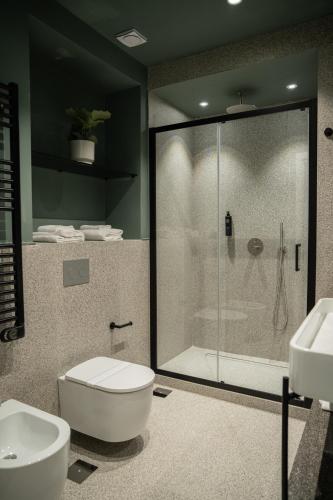 a bathroom with a shower and a toilet and sink at Monteroduni 22 - Chiaia Design Rooms in Naples