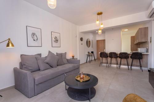 a living room with a couch and a table at City Hall Suites in Limassol