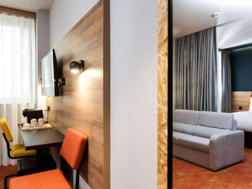 a hotel room with a desk and a bed at greet Tbilisi Center in Tbilisi City
