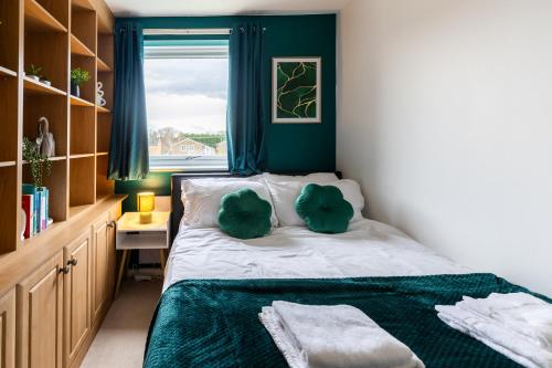 a small bedroom with a bed and a window at Stylish Home Near Addenbrookes Hospital by Traboule Properties Ltd in Shelford
