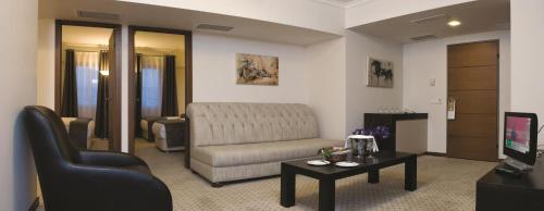a living room with a couch and a table at Blanca Hotel in Izmir