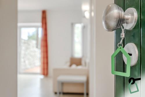 a door knob with a house sign on it at HOTIDAY Apartment Collection - Portoferraio in Portoferraio