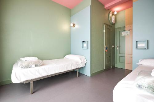 a hospital room with two beds and a hallway at Loop INN Hostel Santiago de Compostela in Santiago de Compostela