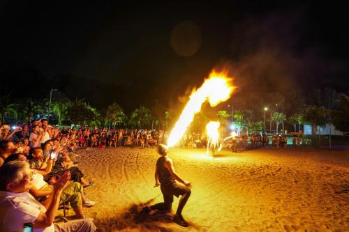 a crowd of people watching a fire show on a beach at Lexis Hibiscus Port Dickson in Port Dickson