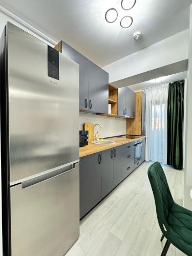 a large kitchen with a stainless steel refrigerator at Luxury Studios at Unique opposite Palas with Parking in Iaşi