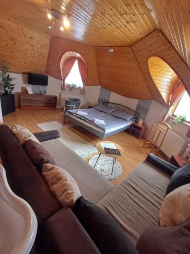a large living room with a couch and a table at Vozi Rooms in Méhkerék