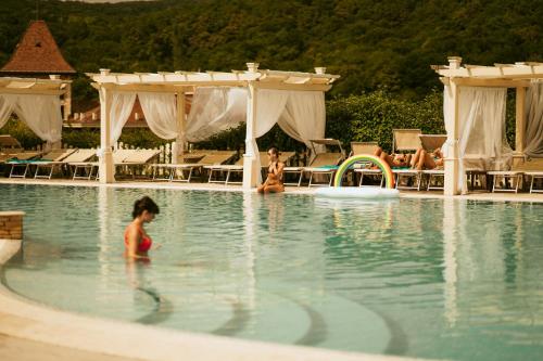 a group of people in the swimming pool at a resort at SunGarden Golf & Spa Resort in Cluj-Napoca