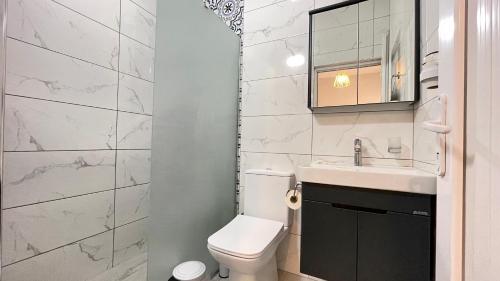a bathroom with a toilet and a sink and a mirror at Jasmin Pansiyon Çıralı in Cıralı