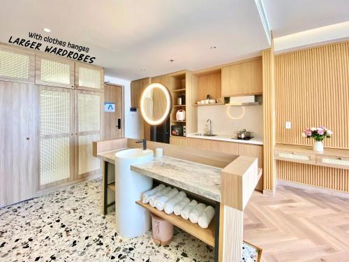 a kitchen with wooden cabinets and a counter top at Luxury SeaView Apartment in 5 star Resort, An Bàng - Hội An in Dien Ban