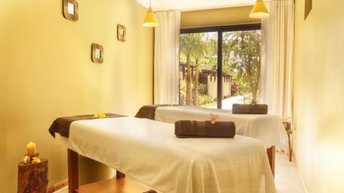 a room with two beds and a window at Wonders Beach Boutique Hotel in Mont Choisy