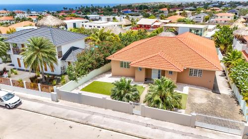 an aerial view of a house with palm trees at Villa Toucan Curacao in Jan Thiel
