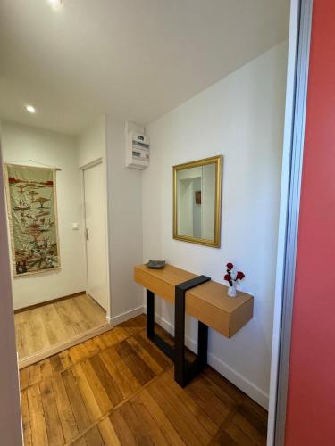 a room with a table and a mirror on a wall at Luxury apartment for 4 people in Blois