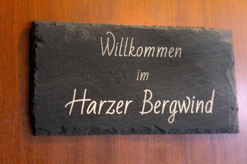 a black sign with the words hallomon in harrar bevind at FeWo Harzer Bergwind Sankt Andreasberg, 1 Hund bis 30Kg willkommen, große eingezäunte Terrasse mit Gasgrill in Sankt Andreasberg