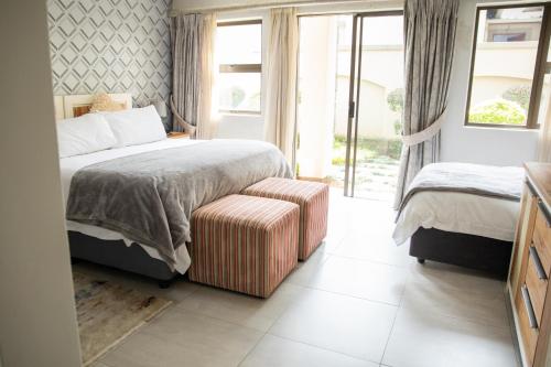 Ένα ή περισσότερα κρεβάτια σε δωμάτιο στο The African Penguin Guesthouse
