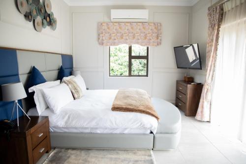 Ένα ή περισσότερα κρεβάτια σε δωμάτιο στο The African Penguin Guesthouse