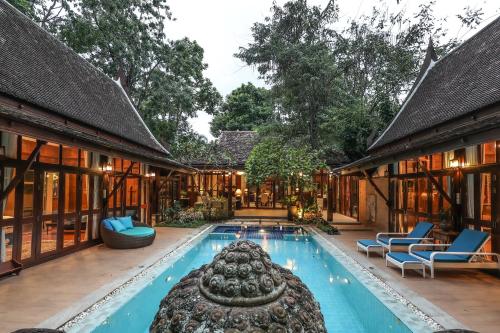 an exterior view of a house with a swimming pool at Luxury Hannah Villas in Chiang Mai