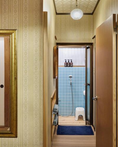 a bathroom with a shower with a toilet in it at 民泊あまやど Amayado in Owase