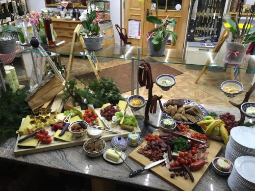 a buffet of food on a table with plates of food at Zum Kirchenbauer in Oberammergau