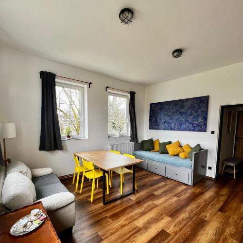 a living room with a couch and a table at Fabrika Doubice & Cifra Gallery in Doubice