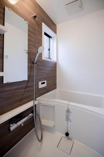 a bathroom with a shower and a tub with a sink at Kawa in Kyoto