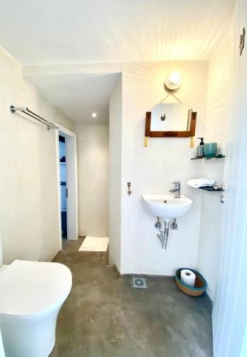 a bathroom with a toilet and a sink at The Bellhouse Kranidi in Kranidi