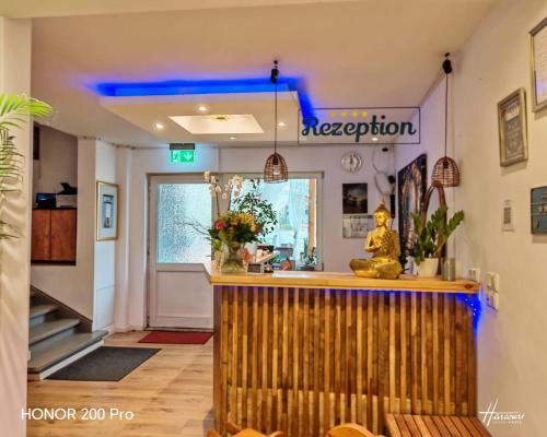 a bar in a restaurant with a blue light at Hotel Radevormwald in Radevormwald