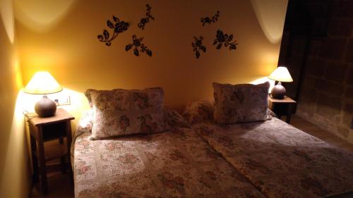 a bedroom with a bed with two lamps on it at Casa Rural Osante in Labastida