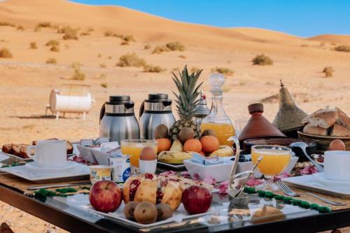 a tray of food on a table in the desert at Your Desert Stay in Merzouga