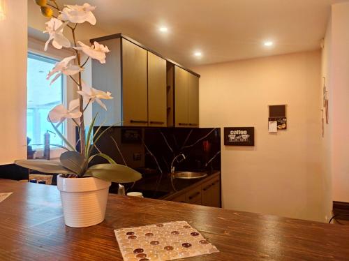 a kitchen with a table with a vase with flowers on it at Villa Lena in Ohrid