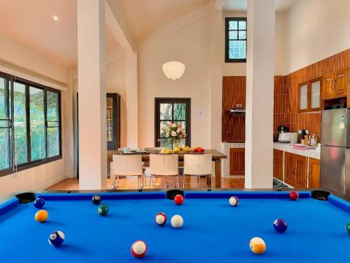 a pool table in a room with a kitchen at The Walden Khaoyai in Mu Si