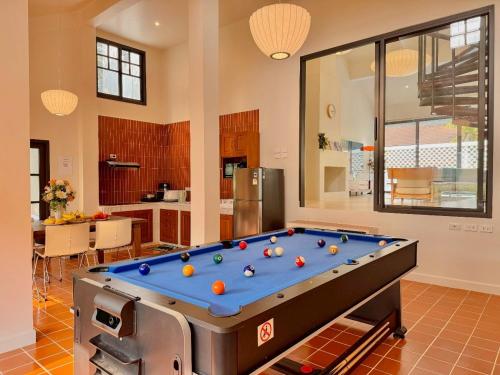 a pool table in the middle of a room at The Walden Khaoyai in Mu Si