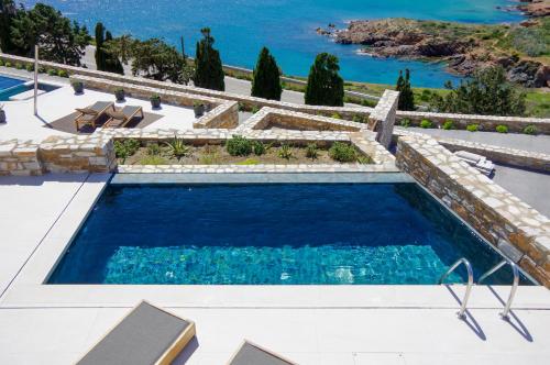 a swimming pool with a view of the ocean at Pnoe Villas Syros in Megas Yialos-Nites