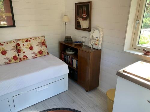 a small bedroom with a bed and a book shelf at Escape to a Seaside Paradise Your Cozy Hideaway in Eckerö