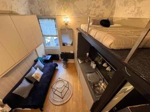 a small room with a bed and a couch at Via Corradi in Sanremo