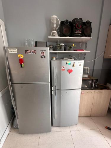two refrigerators in a kitchen next to each other at Glori in Tbilisi City