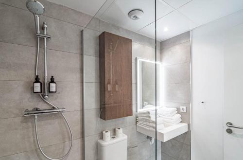a bathroom with a shower with a toilet and a sink at Modern 3 Bedroom Retreat in Benahavís in Benahavís